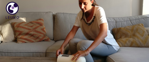 Woman with health tech at a couch and table