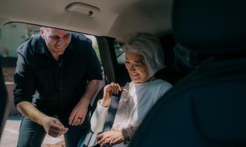 Man assisting women in car